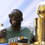 Draymond Green #23 of the Golden State Warriors celebrates with the NBA Championship Trophy during the Golden State Warriors Victory Parade on June 20, 2022 in San Francisco, California. The Golden State Warriors beat the Boston Celtics 4-2 to win the 2022 NBA Finals. NOTE TO USER: User expressly acknowledges and agrees that, by downloading and or using this photograph, User is consenting to the terms and conditions of the Getty Images License Agreement.