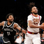 Darius Garland #10 of the Cleveland Cavaliers goes to the basket as Kyrie Irving #11 of the Brooklyn Nets defends during the second half of the Eastern Conference 2022 Play-In Tournament at Barclays Center on April 12, 2022 in the Brooklyn borough of New York City. The Nets won 115-108.
