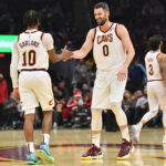 Darius Garland #10 celebrates with Kevin Love #0 of the Cleveland Cavaliersduring the first half against the Houston Rockets at Rocket Mortgage Fieldhouse on December 15, 2021 in Cleveland, Ohio. NOTE TO USER: User expressly acknowledges and agrees that, by downloading and/or using this photograph, user is consenting to the terms and conditions of the Getty Images License Agreement.