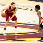 Matthew Dellavedova #18 of the Cleveland Cavaliers looks past Stanley Johnson #5 of the Toronto Raptors for a teammate to pass the ball to at Rocket Mortgage FieldHouse on April 10, 2021 in Cleveland, Ohio.