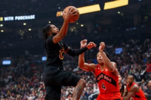 Darius Garland #10 of the Cleveland Cavaliers drives to the net against Scottie Barnes #4 of the Toronto Raptors during the first half of their NBA game at Scotiabank Arena on October 19, 2022 in Toronto, Canada.
