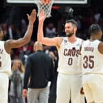 Donovan Mitchell #45 Kevin Love #0 and Isaac Okoro #35 of the Cleveland Cavaliers celebrate during the fourth quarter of the game against the New York Knicks at Rocket Mortgage Fieldhouse on October 30, 2022 in Cleveland, Ohio. The Cavaliers defeated the Knicks 121-108.