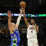 Evan Mobley #4 of the Cleveland Cavaliers shoots over Brook Lopez #11 of the Milwaukee Bucks during the second half of a game at Fiserv Forum on November 16, 2022 in Milwaukee, Wisconsin.