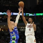 Evan Mobley #4 of the Cleveland Cavaliers shoots over Brook Lopez #11 of the Milwaukee Bucks during the second half of a game at Fiserv Forum on November 16, 2022 in Milwaukee, Wisconsin.