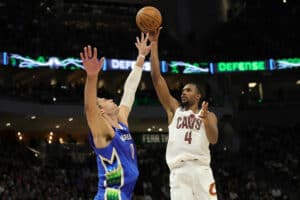 Evan Mobley #4 of the Cleveland Cavaliers shoots over Brook Lopez #11 of the Milwaukee Bucks during the second half of a game at Fiserv Forum on November 16, 2022 in Milwaukee, Wisconsin.