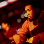 Donovan Mitchell #45 of the Cleveland Cavaliers sits on the bench during the pre-game show as he is illuminated by pyrotechnics before the start of their basketball game against the Toronto Raptors at the Scotiabank Arena on November 28, 2022 in Toronto, Ontario, Canada.