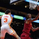 Emoni Bates #21 of the Cleveland Cavaliers drives against Seth Lundy #3 of the Atlanta Hawks during the fourth quarter at State Farm Arena on October 10, 2023 in Atlanta, Georgia. NOTE TO USER: User expressly acknowledges and agrees that, by downloading and/or using this photograph, user is consenting to the terms and conditions of the Getty Images License Agreement.