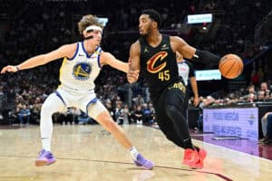 CLEVELAND, OHIO - NOVEMBER 08: Brandin Podziemski #2 of the Golden State Warriors guards Donovan Mitchell #45 of the Cleveland Cavaliers during the first half at Rocket Mortgage Fieldhouse on November 08, 2024 in Cleveland, Ohio. NOTE TO USER: User expressly acknowledges and agrees that, by downloading and or using this photograph, User is consenting to the terms and conditions of the Getty Images License Agreement.