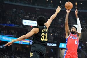 CLEVELAND, OHIO - DECEMBER 21: Paul George #8 of the Philadelphia 76ers shoots a three-point basket against Jarrett Allen #31 of the Cleveland Cavaliers during the first half at Rocket Mortgage Fieldhouse on December 21, 2024 in Cleveland, Ohio. NOTE TO USER: User expressly acknowledges and agrees that, by downloading and or using this photograph, User is consenting to the terms and conditions of the Getty Images License Agreement.