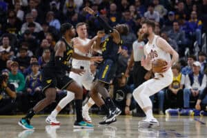 SAN FRANCISCO, CALIFORNIA - DECEMBER 30: Jonathan Kuminga #00 of the Golden State Warriors is fouled off the ball by Sam Merrill #5 of the Cleveland Cavaliers in the second quarter at Chase Center on December 30, 2024 in San Francisco, California. NOTE TO USER: User expressly acknowledges and agrees that, by downloading and or using this photograph, User is consenting to the terms and conditions of the Getty Images License Agreement.