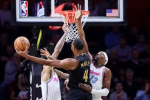 MIAMI, FLORIDA - JANUARY 29: Evan Mobley #4 of the Cleveland Cavaliers drives to the net against Bam Adebayo #13 of the Miami Heat during the first half at Kaseya Center on January 29, 2025 in Miami, Florida.