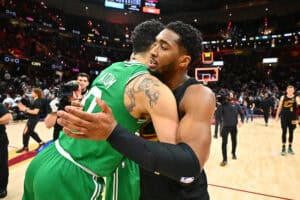 CLEVELAND, OHIO - FEBRUARY 04: Jayson Tatum #0 of the Boston Celtics and Donovan Mitchell #45 of the Cleveland Cavaliers embrace after the game at Rocket Mortgage Fieldhouse on February 04, 2025 in Cleveland, Ohio. The Celtics defeated the Cavaliers 112-105.