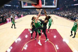 CLEVELAND, OHIO - FEBRUARY 04: Donovan Mitchell #45 of the Cleveland Cavaliers dunks over Kristaps Porzingis #8 of the Boston Celtics during the first quarter at Rocket Mortgage Fieldhouse on February 04, 2025 in Cleveland, Ohio. The Celtics defeated the Cavaliers 112-105.