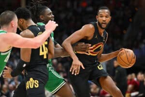 CLEVELAND, OHIO - FEBRUARY 04: Evan Mobley #4 of the Cleveland Cavaliers drives around Jrue Holiday #4 of the Boston Celtics during the third quarter at Rocket Mortgage Fieldhouse on February 04, 2025 in Cleveland, Ohio. The Celtics defeated the Cavaliers 112-105.