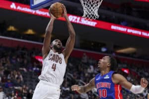 DETROIT, MICHIGAN - FEBRUARY 05: Evan Mobley #4 of the Cleveland Cavaliers goes up for a layup against Ron Holland II #00 of the Detroit Pistons during the fourth quarter of a game at Little Caesars Arena on February 05, 2025 in Detroit, Michigan.