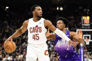 SALT LAKE CITY, UTAH - MARCH 23: Donovan Mitchell #45 of the Cleveland Cavaliers passes around Collin Sexton #2 of the Utah Jazz during the first half of a game at Delta Center on March 23, 2025 in Salt Lake City, Utah.
