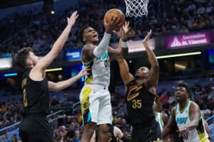 INDIANAPOLIS, INDIANA - APRIL 10: Bennedict Mathurin #00 of the Indiana Pacers attempts a shot while being guarded by Ty Jerome #2 and Isaac Okoro #35 of the Cleveland Cavaliers in the second quarter at Gainbridge Fieldhouse on April 10, 2025 in Indianapolis, Indiana.
