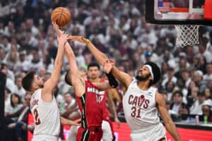 CLEVELAND, OHIO - APRIL 20: Tyler Herro #14 of the Miami Heat tries to shoot over Ty Jerome #2 and Jarrett Allen #31 of the Cleveland Cavaliers during the first quarter of game one of the first round of the Eastern Conference Playoffs at Rocket Arena on April 20, 2025 in Cleveland, Ohio.