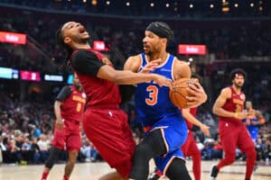 CLEVELAND, OHIO - APRIL 02: Darius Garland #10 of the Cleveland Cavaliers is fouled by Josh Hart #3 of the New York Knicks during the second quarter at Rocket Arena on April 02, 2025 in Cleveland, Ohio.